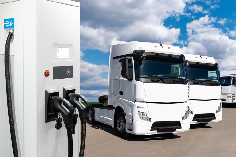 Electric vehicles charging station on a background of a truck. C