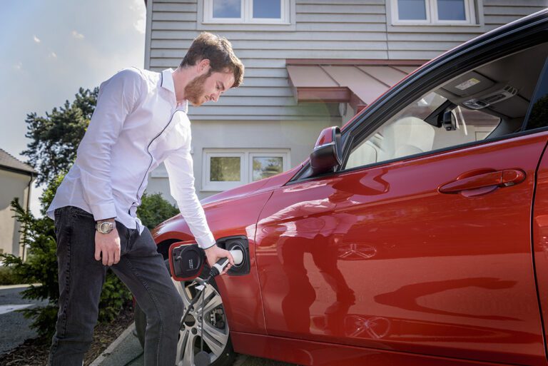 Man charging electric car