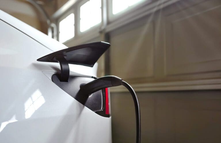 Telsa-plugged-in-garage-AdobeStock_525941109