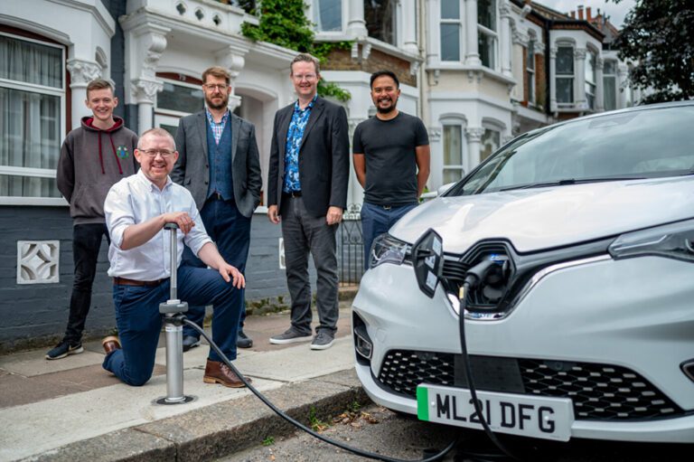 Trojan-Energy-CEO-Ian-Mackenzie-and-team-members-demonstrating-flat-and-flush-EV-charging-point