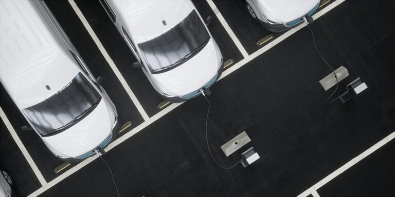 Fleet of generic electric EV delivery vans charging on charging stations