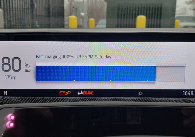 The short, wide 'instrument cluster' screen behind the steering wheel has crisp graphics