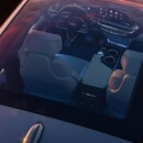 Overhead image of the 2023 Cadillac LYRIQ looking through the full glass roof to the inside of the vehicle.